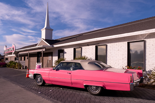 Las Vegas, NV, 1/16/2024 Vegas Wedding Chapel near the Las Vegas Strip, a pink convertible vintage Cadillac is parked at the entrance
