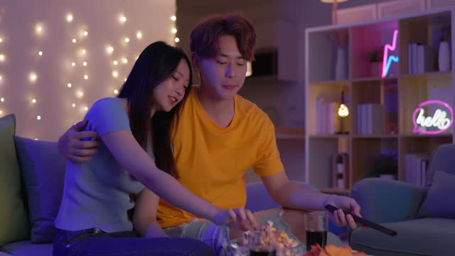 Asian couple watch TV home