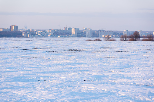 Panorama of the city and a snow-covered field landscape