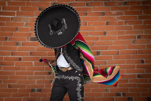 Mexico City, Mexico September /13/2021 Mexican charro dancer from Jalisco Mexico with a multicolored striped serape and large hat with silver decorations