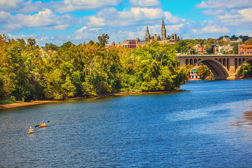 Key Bridge Potomac River Kayaks Georgetown University Washington DC from Roosevelt Island.  Completed in 1923 this is the oldest bridge in Washington DC.