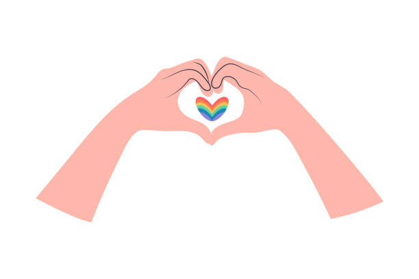 istock Two hands making heart sign and rainbow heart between. Love gesture. Rainbow colors of LGBT pride flag. 1961366352