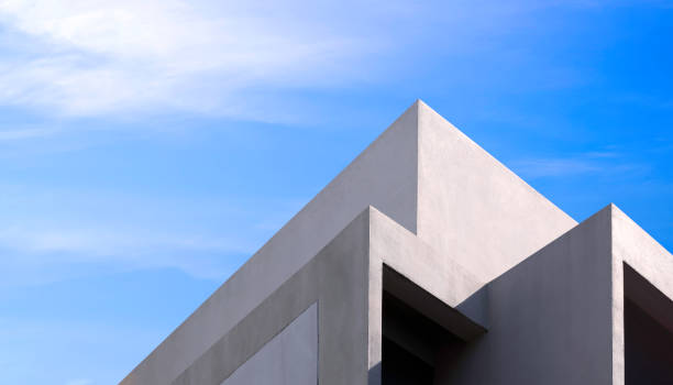 istock Modern geometric building against blue sky in low angle and perspective side view 1961390357