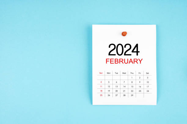 istock February 2024 calendar page with push pin on blue background. 1961429028