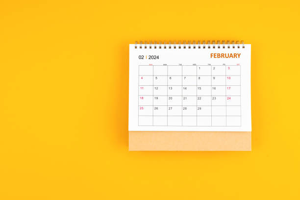 istock February 2024 desk calendar on yellow color background, position with copy space. 1961429029