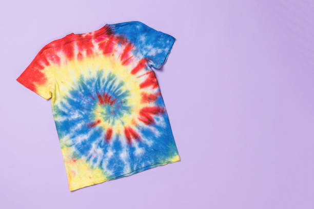 istock Stylish bright tie dye T-shirt on a purple background. 1961443304