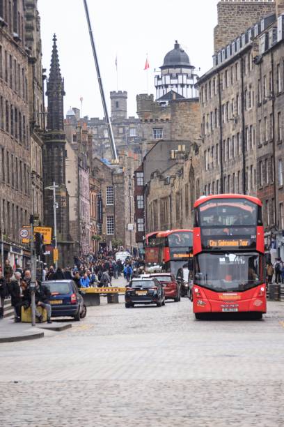 istock Bustling Edinburgh Street with Iconic Red Buses 1961480297