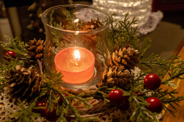 istock Burning holiday candle on a table in low light 1961528279