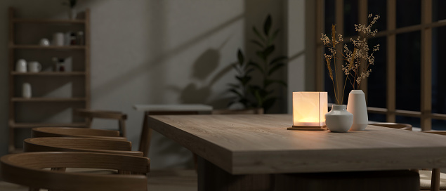 Close-up image of a hardwood dining table with a table lamp in a cosy, romantic restaurant at night. 3d render, 3d illustration