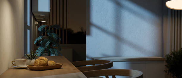 istock A side-view image of a dining table against the wall in a dining room at night with dim lighting. 1961561298