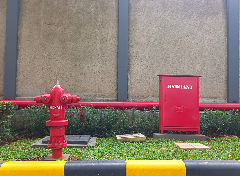 Tangerang, Indonesia 26 December 2023 a hydrant box and hydrant pillars outside a building