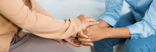 Close up shot of supportive and comforting hands for crucial empathy Close up shot of supportive and comforting hands for cheering up depressed patient person or stressed mind with crucial empathy woman comforting depressed friend stock pictures, royalty-free photos & images