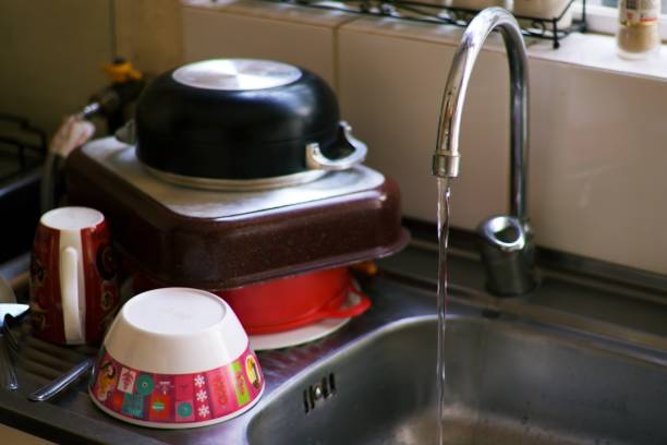 istock sink, running water and washed kitchen utensils 1961663922