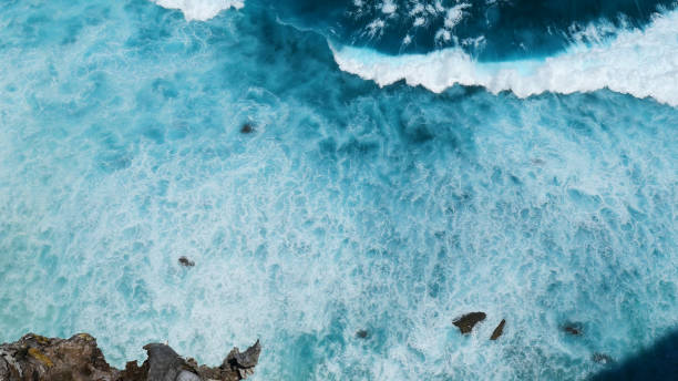 istock Turquoise ocean sea water white wave pattern splashing deep blue sea. Seascape dark ocean background wave splash on rock. Tropical sea beach in summer seaside outdoor. Water Surface blue wave pattern 1961668564