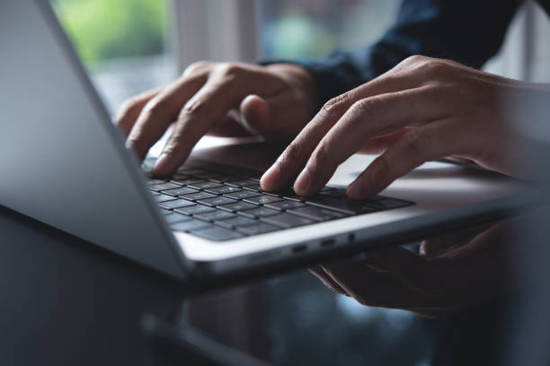 istock Business man hands typing on laptop computer keyboard, searching information, surfing the internet on dark office desk, distance job, online working, business and technology concept 1961727221
