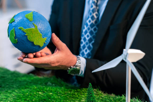 istock Businessman or CEO holding paper globe in office. Quaint 1961729402