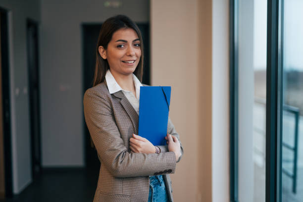 istock Beautiful young businesswoman holding a folder 1961730468
