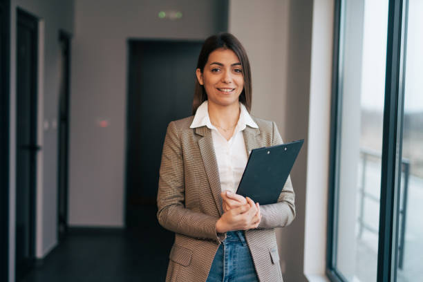 istock Beautiful young businesswoman holding a folder 1961734689