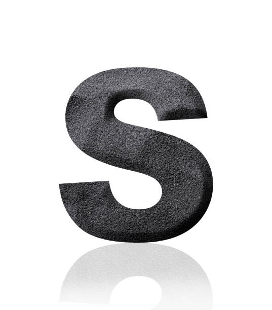 istock Isolated shot of three-dimensional black sand alphabet letter S on white background 1961740875