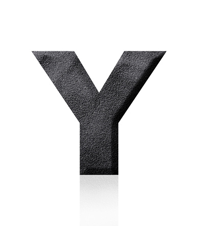 Close-up of three-dimensional black sand alphabet letter Y on white background.