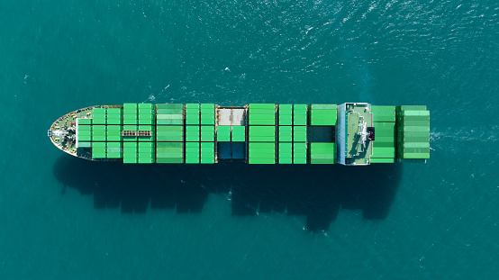 Green Cargo Container Ship, Cargo Container only green color. container ship running in the ocean to shipyard sea port. import shipping industry freight logistics. Concept green transportation environment
