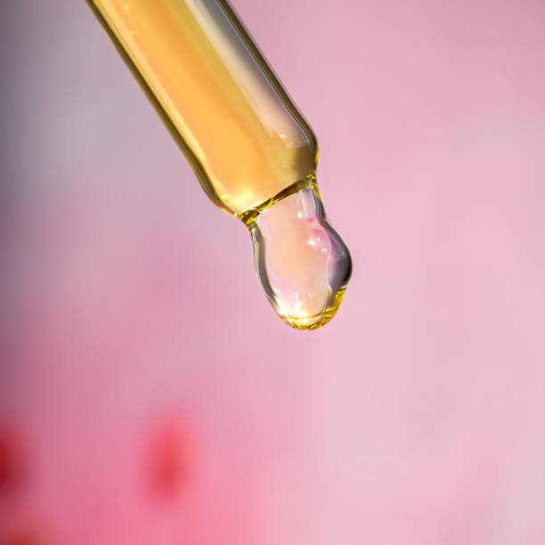 istock A drop of cosmetic aromatic oil drips from the pipette. Front view. 1961775659