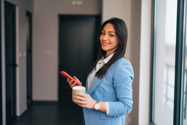 istock Young businesswoman using mobile phone and text messaging 1961778883