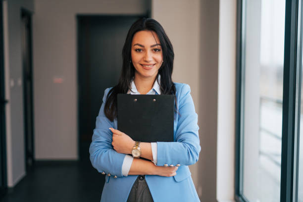 istock Beautiful young businesswoman holding a folder 1961779192