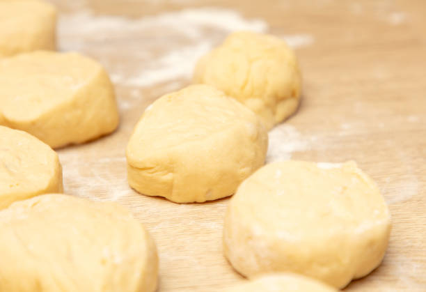 istock Pieces of dough on the table in flour. 1961779329