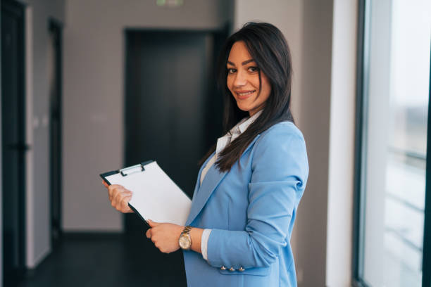 istock Beautiful young businesswoman holding a folder 1961779333