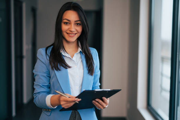 istock Beautiful young businesswoman holding a folder 1961779373