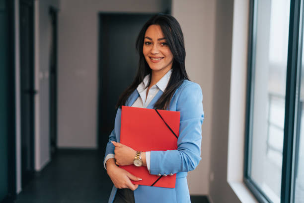 istock Beautiful young businesswoman holding a folder 1961779390