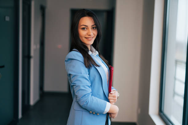 istock Beautiful young businesswoman holding a folder 1961779518