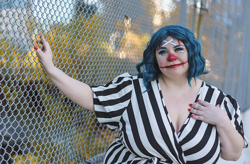 Portrait of a young woman with Joker make up on the street. New York City