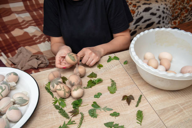 istock A girl cooks eggs in tights with leaves. Easter 1961779861