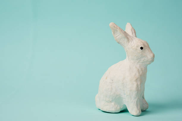 istock Festive white rabbit toy on a blue background with pastel colors Easter 1961789644