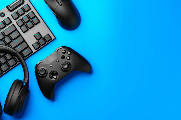 istock Computer keyboard and joystick on blue background top view 1961793861
