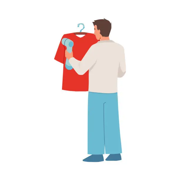 Vector illustration of Man using manual garment steamer, ironing a red t-shirt on hanger, vector portable home and travel garment steamer