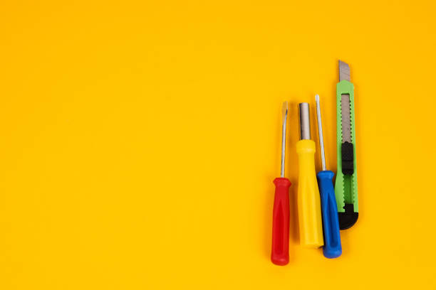 istock stationery knife screwdrivers and construction tools on yellow background equipment for repair industry 1961798795