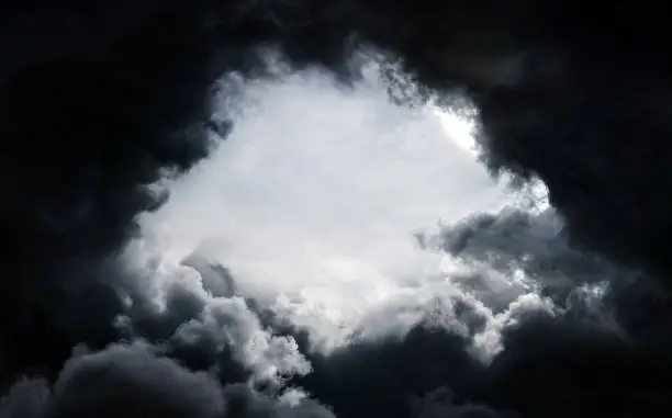 Hole in the Dark and Dramatic Storm Clouds