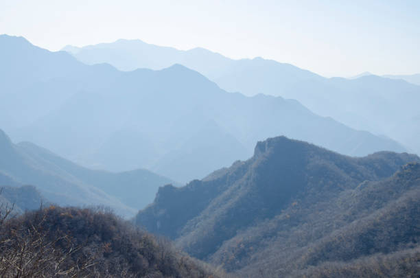 Blue mountains in the fog. Seamless background.