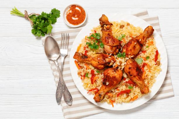 istock fried chicken drumsticks over rice pilaf, top view 1961843779