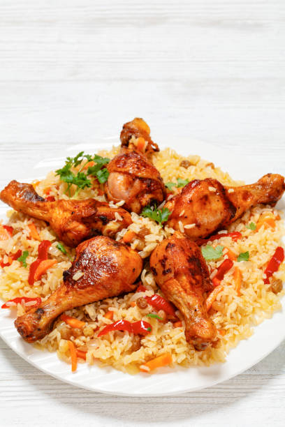 istock fried chicken drumsticks over rice pilaf, top view 1961844134