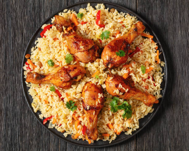 istock fried chicken drumsticks over rice pilaf, top view 1961844307