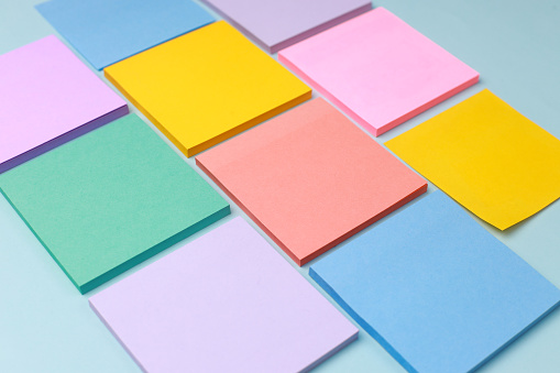 Colorful Paper Notes Arrange Neatly on Blue Background