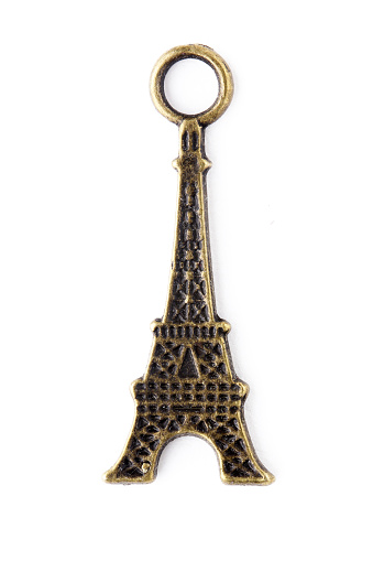 The metal Eiffel Tower pendant is isolated against a white background.