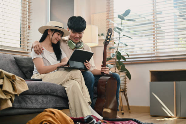istock Attractive young couple using digital tablet for search travel trip online 1961911009