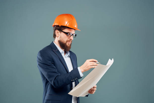 istock Engineer in orange paint job industry professional construction blue background 1961934154