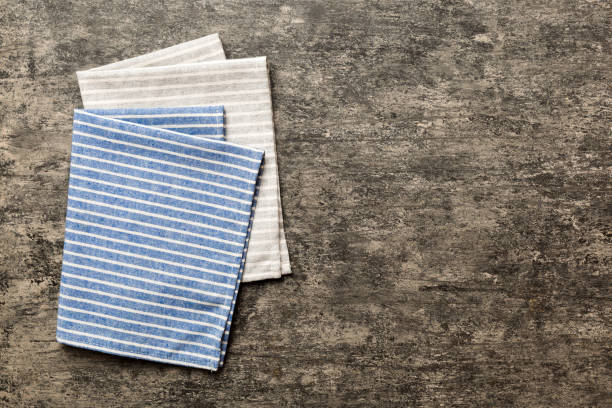 istock top view with blue kitchen napkin isolated on table background. Folded cloth for mockup with copy space, Flat lay. Minimal style 1961939478