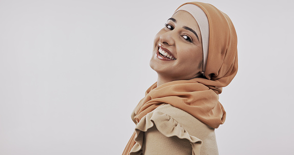Muslim, happy woman and face with beauty, skincare with Islamic fashion and dermatology on white background. Portrait, natural cosmetics and mockup space, model in hijab and modest clothes in studio
